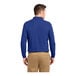 A man wearing a Port Authority® royal blue long sleeve polo shirt.