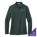 A small dark green Port Authority women's long sleeve polo shirt on a table with gold embroidery.