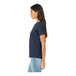 A woman wearing a Bella + Canvas heather navy short sleeve t-shirt.
