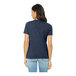 A woman wearing a Bella + Canvas heather navy blue short sleeve tee shirt.