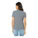 A woman wearing a Bella + Canvas athletic heather grey customizable t-shirt.