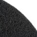 A close up of a black Scrubble by ACS 19" stripping floor pad.
