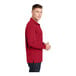 A man wearing a deep red Sport-Tek long sleeve polo shirt.