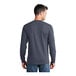 A man wearing a Port & Company Heather Navy long sleeve t-shirt.