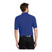 A man wearing a royal blue Port Authority K500 Silk Touch Pique Polo Shirt.