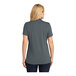 A woman wearing a graphite Port Authority Dry Zone polo shirt.