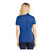 A woman wearing a Sport-Tek True Royal short sleeve polo shirt.