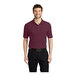 A man wearing a Port Authority burgundy polo shirt.