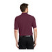 A man wearing a burgundy Port Authority polo shirt.