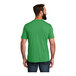 A man wearing a green AllMade short sleeve t-shirt.