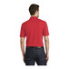 A man wearing a Port Authority Rich Red short sleeve polo shirt.