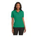 A woman wearing a Kelly green Port Authority polo shirt.