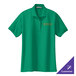 A close-up of a Kelly green Port Authority polo shirt with a logo on it.