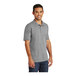 A man wearing a Port & Company athletic heather polo shirt.