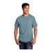 A man wearing a Port & Company stonewashed blue short sleeve T-shirt.