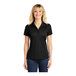 A woman wearing a black polyester Sport-Tek short sleeve polo shirt.