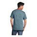 A man wearing a Port & Company stonewashed blue T-shirt.