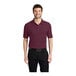 A man wearing a burgundy Port Authority® Silk Touch Pique polo shirt.