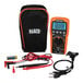 A Klein Tools digital multimeter with black and orange casing and wires.