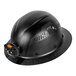 A black Klein Tools carbon fiber hard hat with an LED light on it.