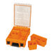 An orange plastic container with four compartments and a black border.