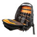 A black and orange Klein Tools backpack with a zippered inside.