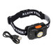 A Klein Tools headlamp with a black fabric strap and a USB cable.
