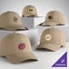 A collection of customizable khaki 6-panel dad caps with various logo designs displayed on each hat.