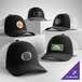 A collection of customizable black and white 5-panel trucker caps with mesh backs and various logo patches displayed on the front.