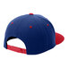 A blue hat with red buttons and a red brim with a red button on top.