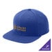 A blue Sport-Tek snapback cap with gold text on the front.