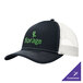 A navy and white Port Authority trucker cap with white mesh and a white and green logo.