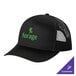 A black trucker cap with green text on the front mesh panel that says "forge".