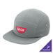 A close-up of a deep smoke colored Port Authority camper cap with the word "wok" on it.