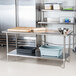 A stainless steel Advance Tabco work table with undershelf.