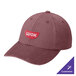 A maroon Port Authority dad cap with a logo on it reading "wok" on a table in a professional kitchen.