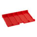 A red plastic seat for a shopping cart with four compartments.