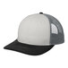 A white and black trucker cap with a mesh back.