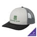 A white Port Authority trucker cap with a black and white mesh back.