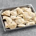 A tray of Jaju Jalapeno Cheddar Pierogies on a gray surface.