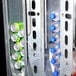 A Selectivend cold drink vending machine with a metal rack holding soda cans and plastic bottles.