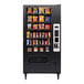 A white vending machine with snacks and chips on shelves.