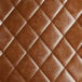 A brown tufted leather cushion.