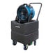 An XPOWER blue and black portable air circulator fan on a black container.
