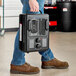 A person carrying a Boltic portable electric milkhouse heater.