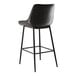 A Lancaster Table & Seating black metal bar stool with black tufted vinyl seat.