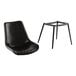 A Lancaster Table & Seating black mid-century chair with black tufted vinyl seat on a patio.