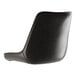 A Lancaster Table & Seating black vinyl tufted chair cushion on a black leather chair with a curved back.