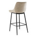 A Lancaster Table & Seating black barstool with a beige tufted seat.