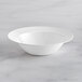 A white Visions plastic coupe bowl on a marble surface.